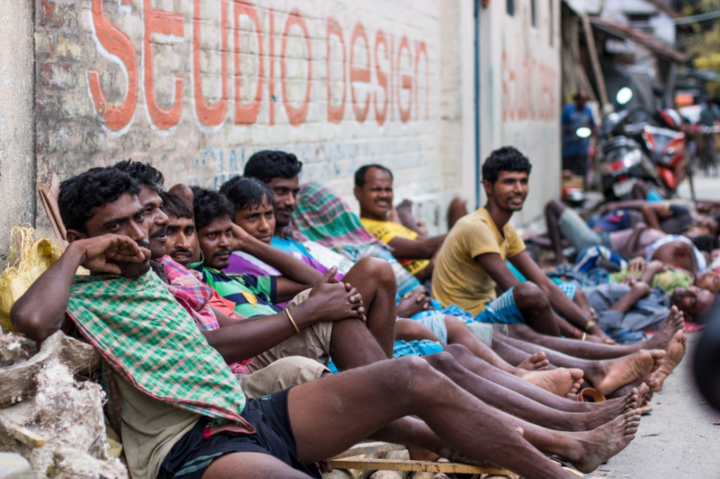 Un grupo de porteadores descansa en una calle durante su tiempo libre. 